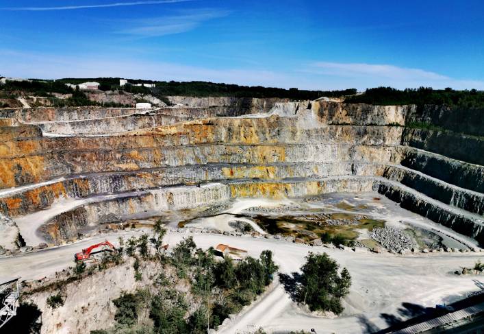 A large open pit with many levels of rock.