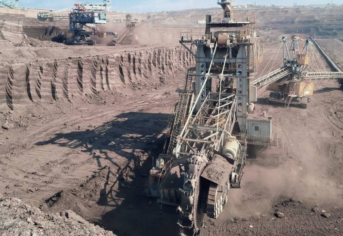 A large machine in the middle of an open pit.